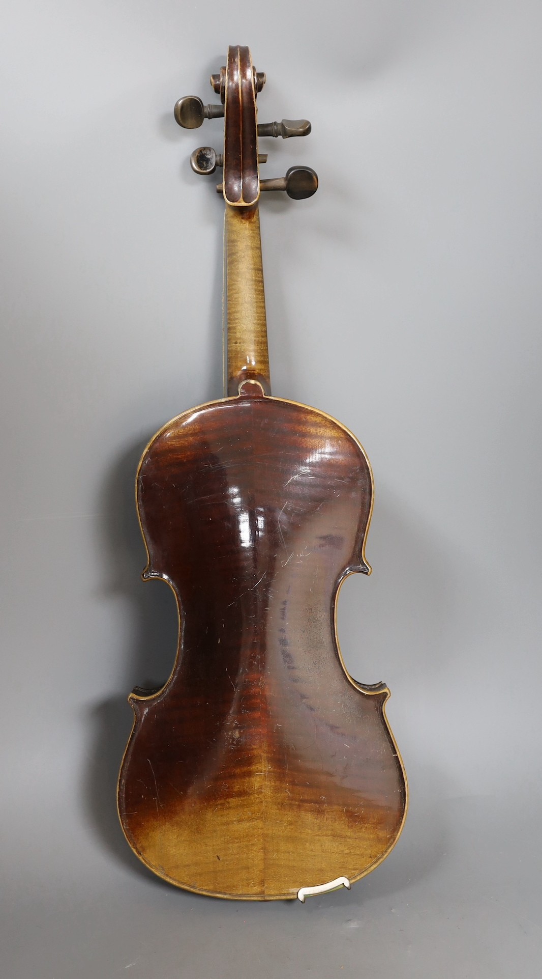 A cased German violin, labelled Stradivarius and dated 1886, back measures 36cm excl button